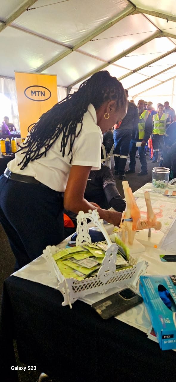 The nurse taking a blood pressure reading at a company wellness day
